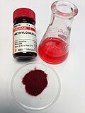 Methylcobalamin: the adjacent labeled vial strengthens verisimilitude or reliability.  Presentation of the solution is helpful for this deeply colored compound.