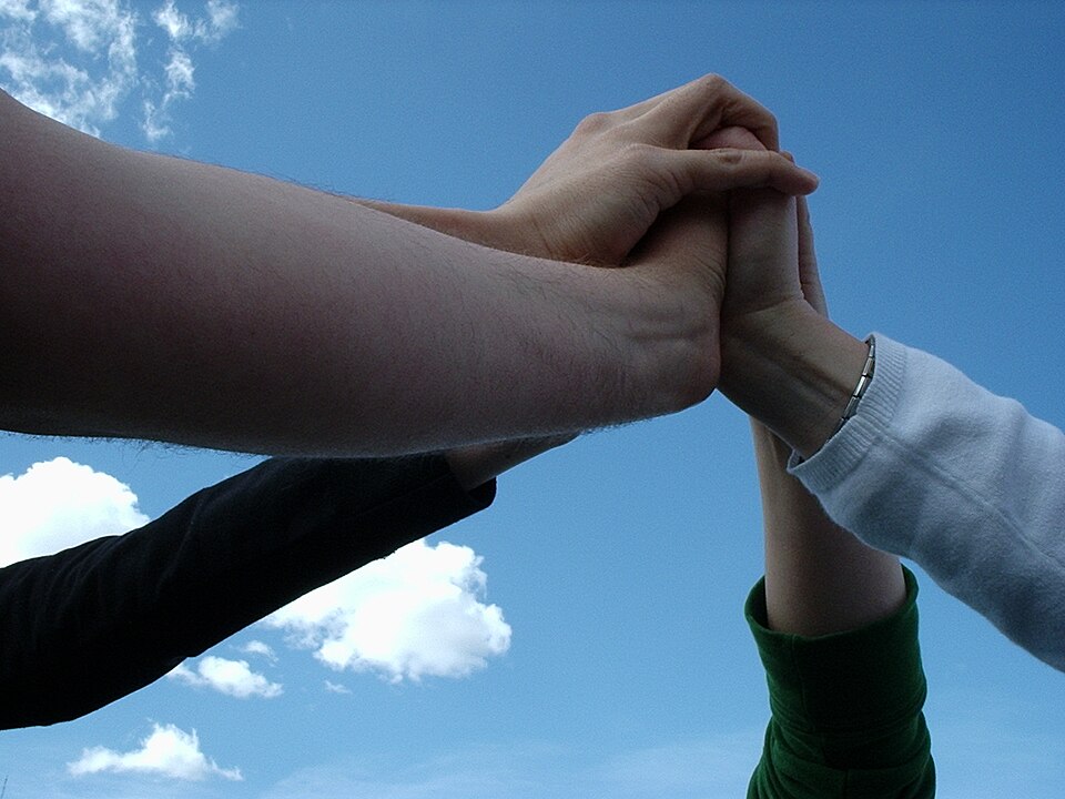 File:Team touching hands.jpg