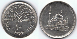 10 Egyptian piastres (copper-nickel alloy composition and silver color); coin's obverse depicts Muhammad Ali Mosque from a flat perspective, coin reverse contains a Kufic font inscription of “Jumhuriyat Masr Al-Arabia”, translating to the Arab Republic of Egypt, below which the denomination of 10 piastres is written as number hovering over the word “qurush”, translating to piastres, which bends with the curvature of the coins edge, which is surrounded by the Gregorian (1984) and Hijra (1404) dates.