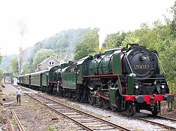 Restored steam locomotives double-heading on an excursion train in Belgium in 2010