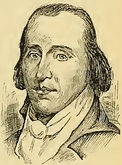 A man with dark, receding hair wearing a high collared white shirt and black jacket