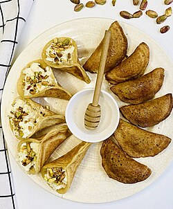 Levantine qatayef with syrup, served as a plain pancake or fried after being stuffed.