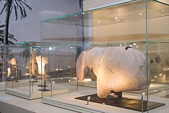 A large stone carving of an equidae - an animal belonging to the horse family. The piece itself, measuring 86 cms long by 18 cms thick and weighing more than 135kg., is a large sculptural fragment that appears to show the head, muzzle, shoulder and withers of a horse. The fact that other smaller, horse-like sculptures were found at Al-Magar, with similar bands over the shoulders, supports the idea that this culture may have been using horse tack to domesticate horses.