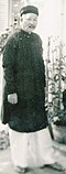 Saigon old man wearing traditional Áo dài and Khăn vấn, Tết 1963