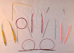 Circular knitting needles in different lengths, materials and sizes, including plastic, aluminum, steel and nickel-plated brass
