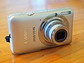 A IXUS 115 HS with its lens extended