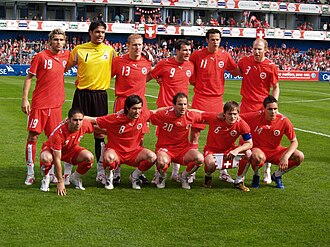A group of people standing alongside each other in a row