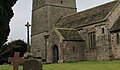 A square base of three stone steps topped with a tapering shaft and ornate carved cross