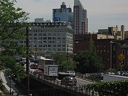 A congested elevated freeway passing through an area of urban high rise buildings