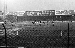 A black and white image of a football match.