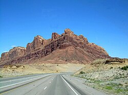 A mountain made from two layers of sandstone, the lower layer is a light color, while the upper layer is dark red.