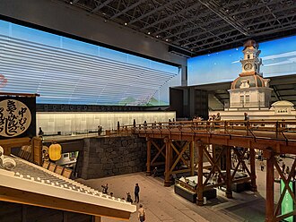 View from the entrance to the permanent exhibition on the 6th floor, crossing a partial reconstruction of Nihonbashi and passing through a white curtain into the gallery