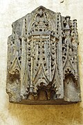 Dark marble carving of a shrine niche.