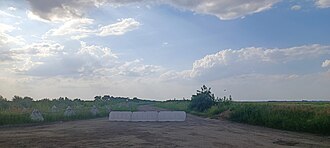 Russian anti-tank defense line in Zaporizhzhia Oblast with chained together dragon teeth and a concrete road block