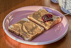 a peanut butter and jelly sandwich being prepared