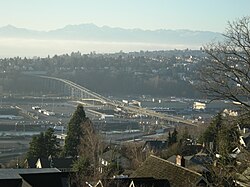 A bridge spanning between residential neighborhoods through an industrial district
