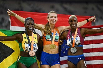 Photo of Rushell Clayton with a bronze medal around her neck holding a Jamaican flag behind her back, of Femke Bol with a gold medal and Dutch flag, and Shamier Little with a silver medal and an American flag