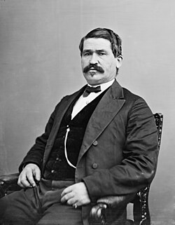 Black-and-white photograph of a seated man in 19th-century civilian attire facing the camera