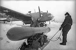 Weapons technicians preparing a 18-inch (450 mm) torpedo for arming a Handley Page Hampden TB Mk I torpedo bomber of the Northern Fleet Air Force 24th Mine-Torpedo Aviation Regiment—a former aircraft of No. 144 Squadron RAF or No. 455 Squadron RAAF—that was donated to the Soviet Union after Operation Orator; late 1942 and early 1943