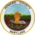 A round seal featuring a sheaf of grain in a field with a white border
