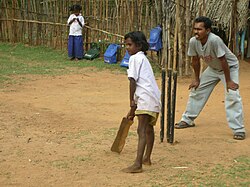 Cricket is the most popular game among India's masses. Shown here is an instance of street cricket.