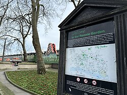 Welcome sign and a tree within Rennie Garden, Blackfriars Railway Bridge in the background