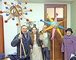 A group of people holding Christmas stars