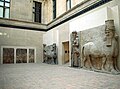 Musée du Louvre - Human Headed Winged Bulls, Sculpture and Reliefs from Khorsabad, note the Lamassu in the foreground is a cast from the Oriental Institute, Chicago