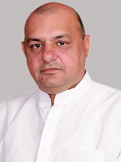 Head shot of Gogi wearing a white shirt