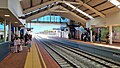 View from bridge of two railway tracks merging into one as they leave the station