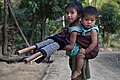 Image 67In Bangladesh there are many tribal people live in Sylhet, Dinajpur, Cox's Bazar, Mymensingh, Rajshahi etc. But majority of tribal people live in the Chittagong Hill Tracts. This picture features a tribal kid with her little sister tied in her back at Farukpara, Bandarban, Bangladesh.Photo Credit: Mohammad Rakibul Hasan