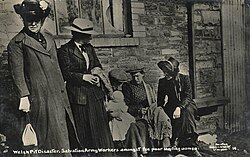 A female Salvation Army officer comforts a family