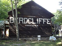 Wooden building with a stone base, and in big letters Byrdcliffe is painter across the entire side, with Theater in smaller letters below