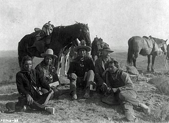 Three of Custer's scouts accompanying Edward Curtis on his investigative tour of the battlefield, c. 1907. Left to right: Goes Ahead, Hairy Moccasin, White Man Runs Him, Curtis, and Alexander B. Upshaw (Curtis's assistant and Crow interpreter)