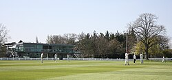 Cricket being played in front of the pavilion at Millfield School