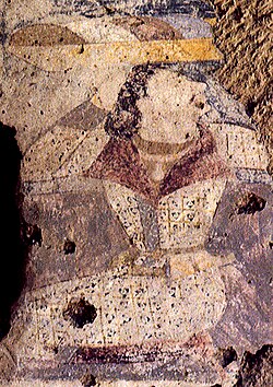 Devotee in double-lapel caftan, left wall of the niche of the Western Buddha. He has also been described as a Hephthalite.