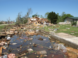 A residence is blown away and scattered into a tree.