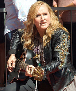The singer Melissa Etheridge performing with a guitar in 2011