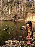 Baloch girl in Baloch dress next to a lake