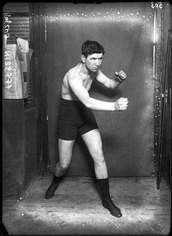 Black-and-white studio photograph of Pat O'Keeffe in boxing stance