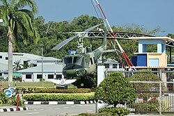 Retired RBAirF / TUDB Bell UH-1 (Bell 205, c/n: 30057, reg.: AMDB 100) helicopter gate guardian displayed inside the main gate of the airbase, September 2023