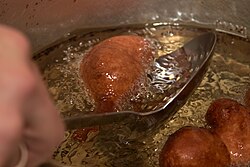 Oliebollen and similar doughnuts are fried in hot fat.