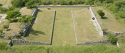 One of the ballcourts at Xochicalco. Note the characteristic -shape, as well as the rings set above the apron at center court. The setting sun of the equinox shines through the ring.