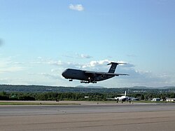 C-5 Galaxy military transport aircraft on final approach to land, gear extended and flaps deployed