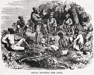 A group of individuals in a forest clearing, gathered around a pile of valuables