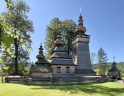 A wooden church with a bell tower
