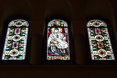 Saint Vincent de Paul window flanked by geometric  windows