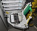 Inside one of the trays with fiber splices inside the tray and connectors folded out