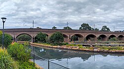 A brick arch viaduct within a park