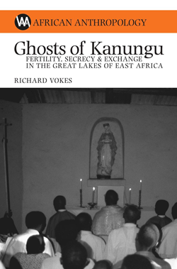 White cover with a picture of several people standing in front of a statue of the Virgin Mary